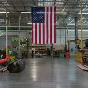 installer using a stake to secure turf
